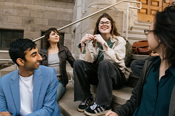 people sitting on steps in front of a building