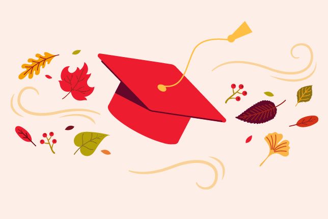 Bright red graduation cap with autumn leaves and decorative swirling accents.