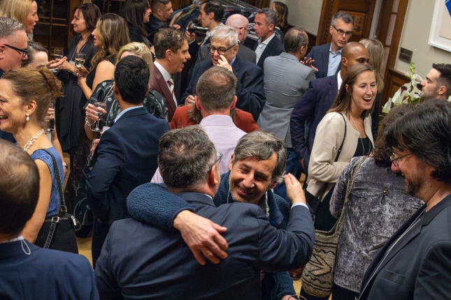 Alumni hugging and smiling